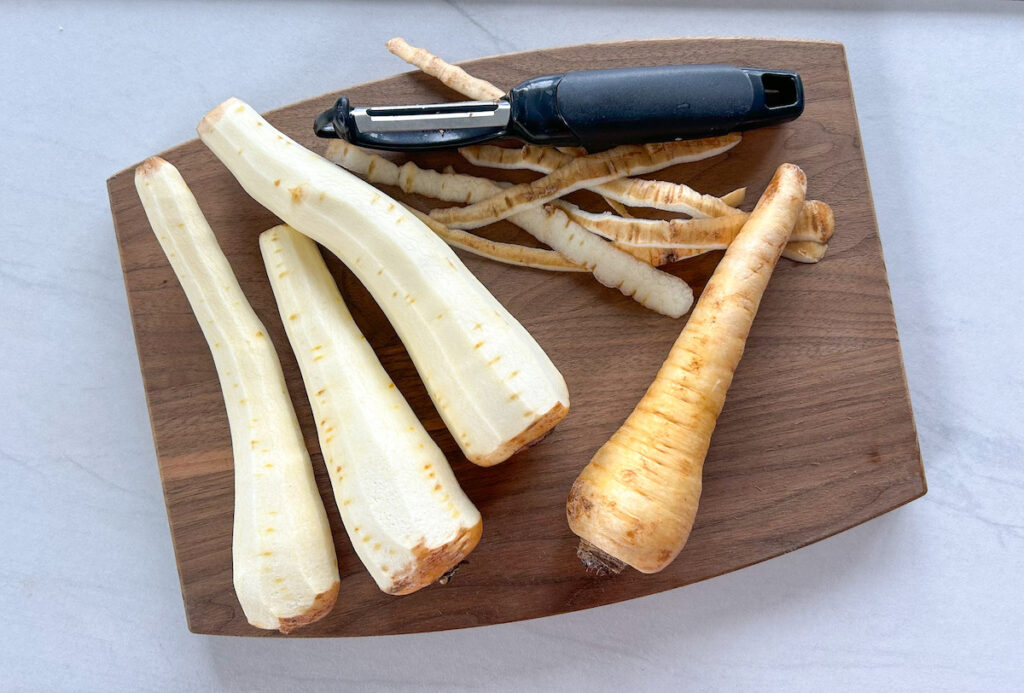 several parsnips peeled on a cutting board