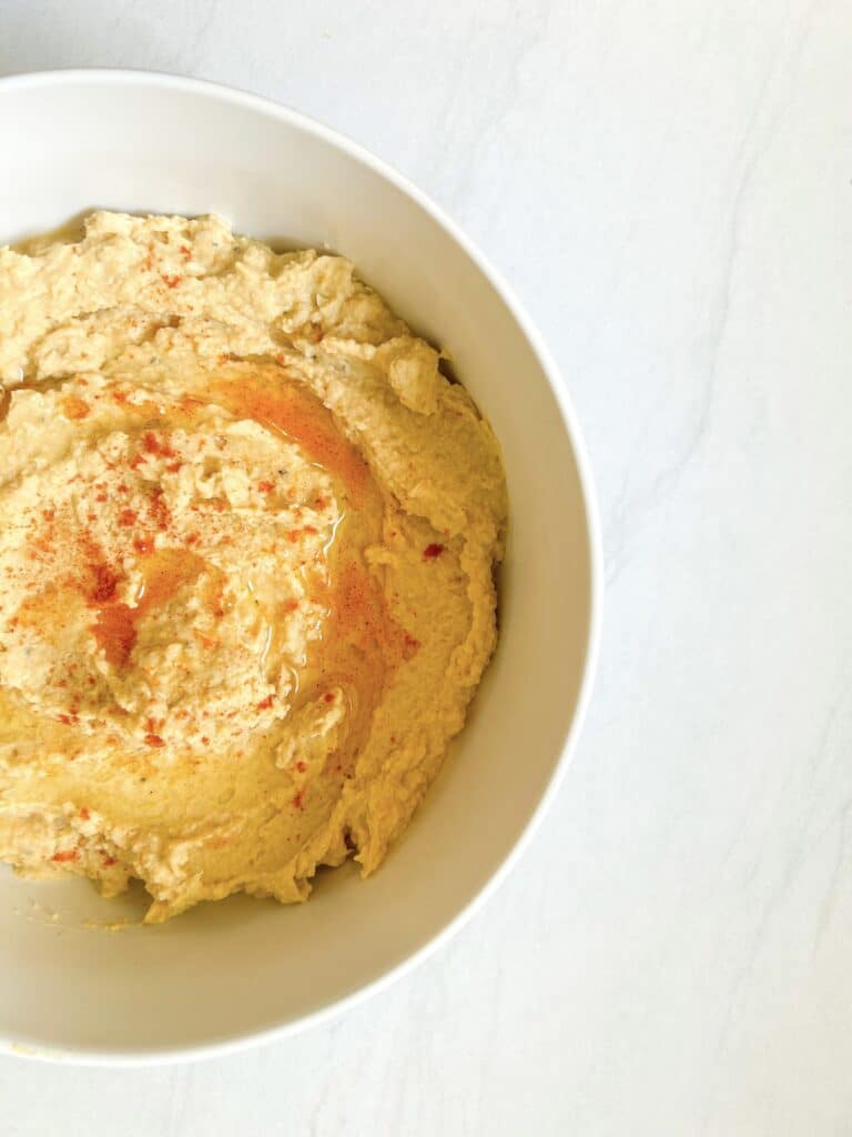 homemade hummus in a white bowl