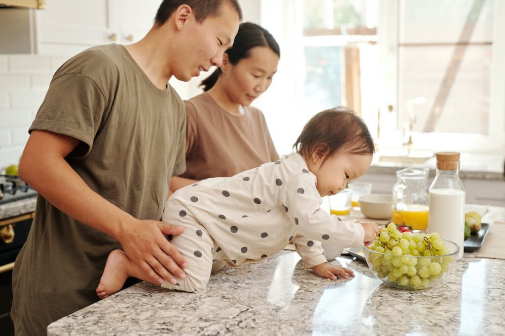 toddler eating grapes with parents