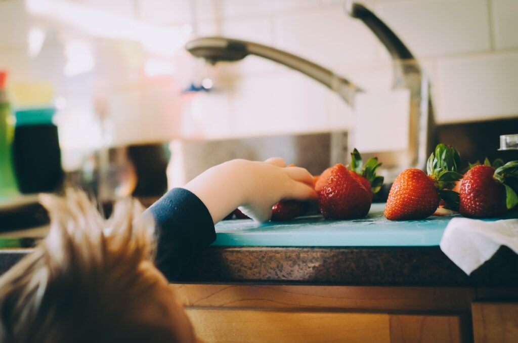 kid reaching onto counter