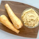 parsnip puree and two parsnips on a cutting board