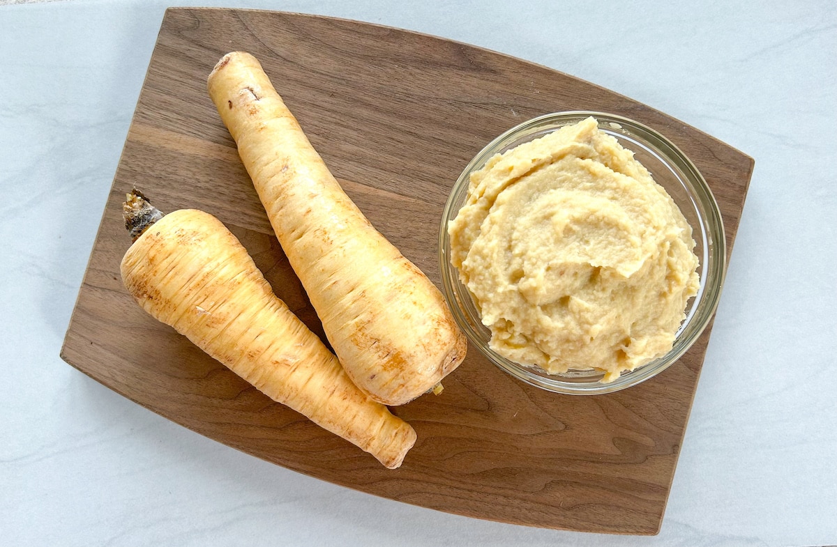 parsnip puree and two parsnips on a cutting board