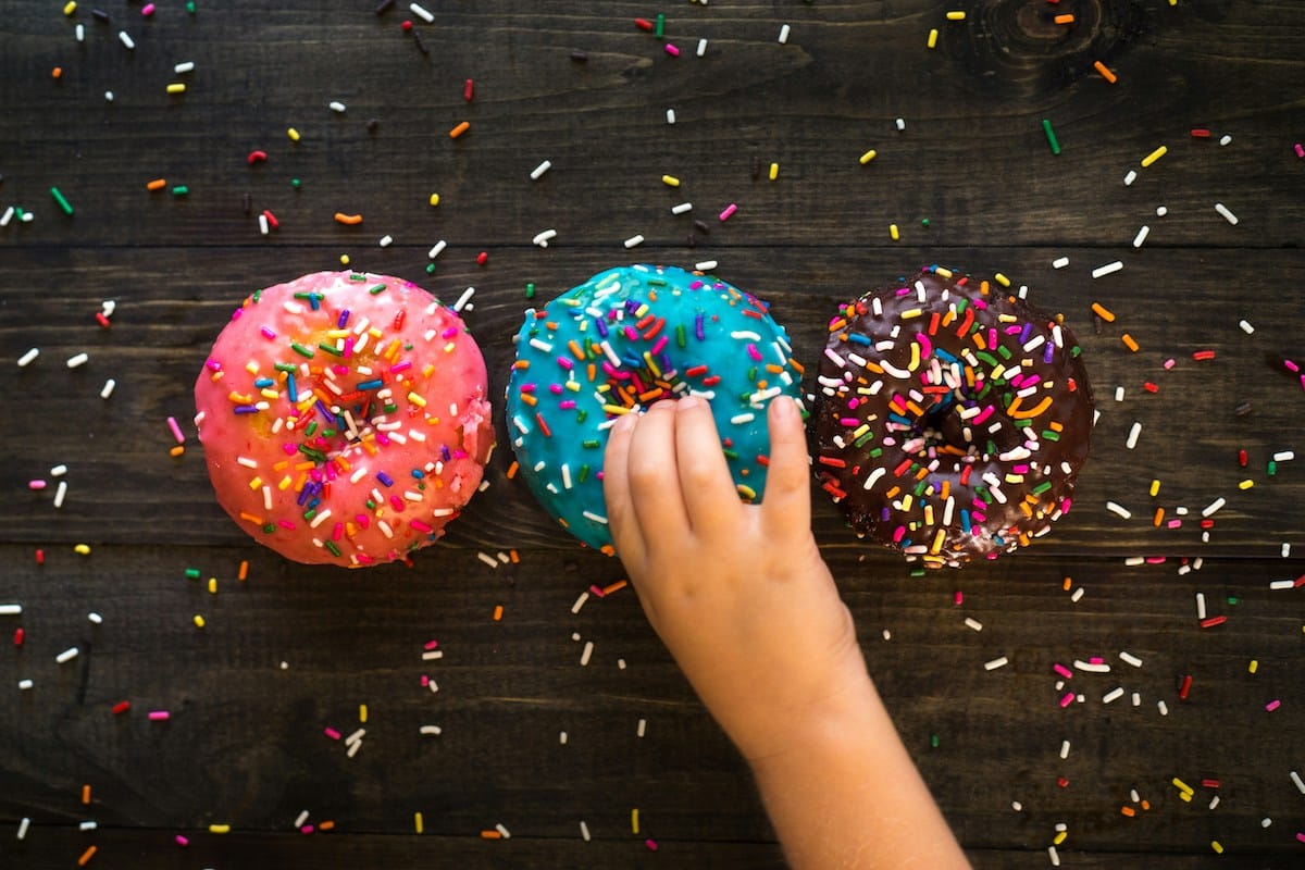 child with autism picking up a donut