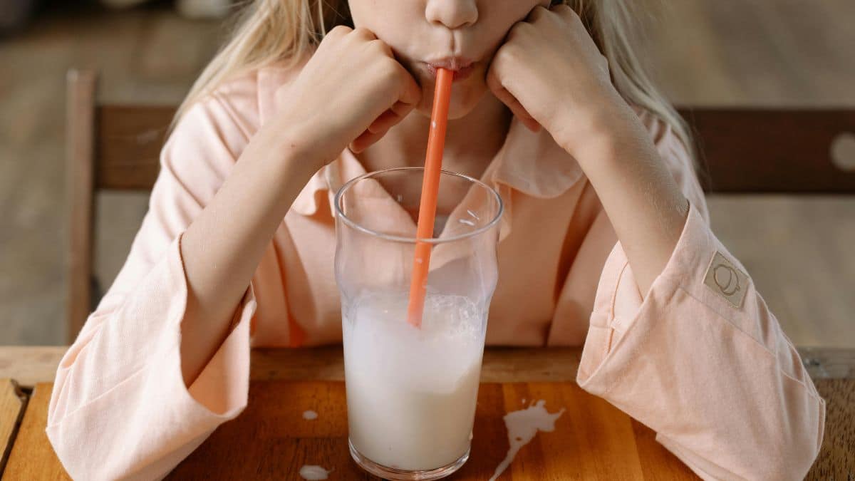 kids drinking milk on a table