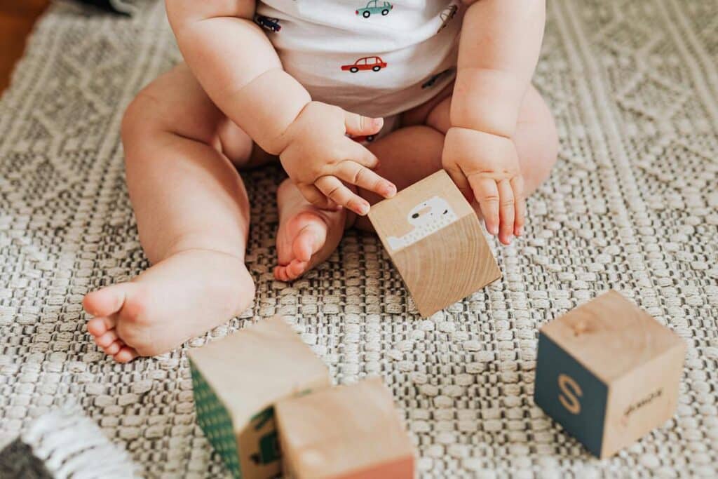 baby doing sensory activities with blocks