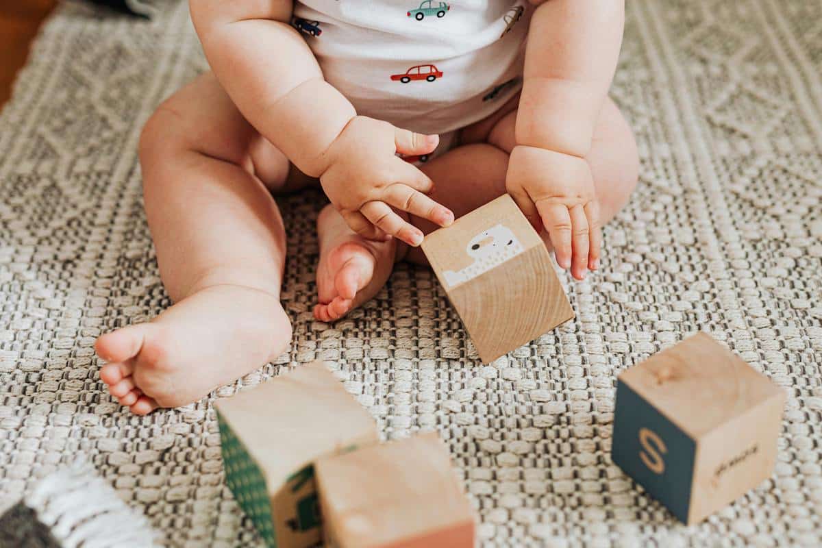 baby doing sensory activities with blocks